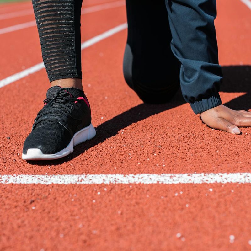 Close-up shot of feet in athletic shoes ready to start moving.
