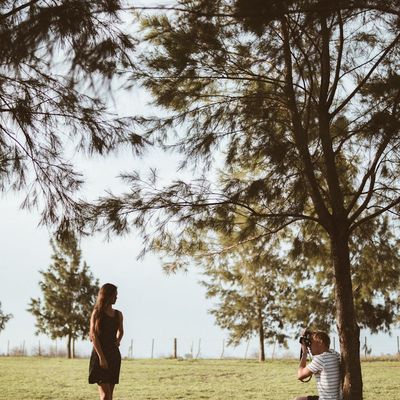 Person taking a deep breath in a serene outdoor setting.